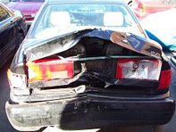 Car damage after hit from behind in accident.