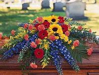 Flowers on coffin in cemetery.